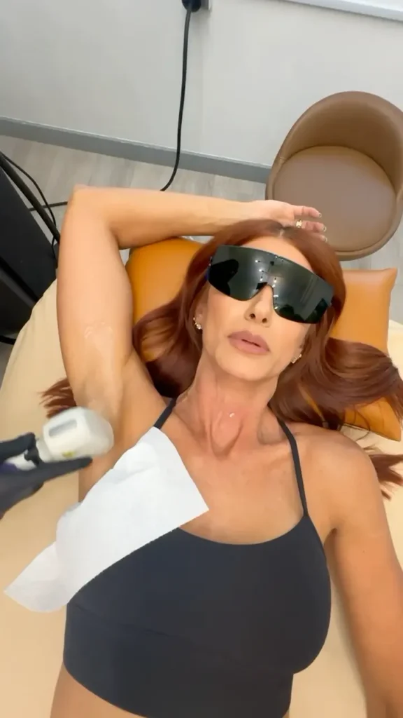 Close-up view of laser hair removal device on a treatment bed